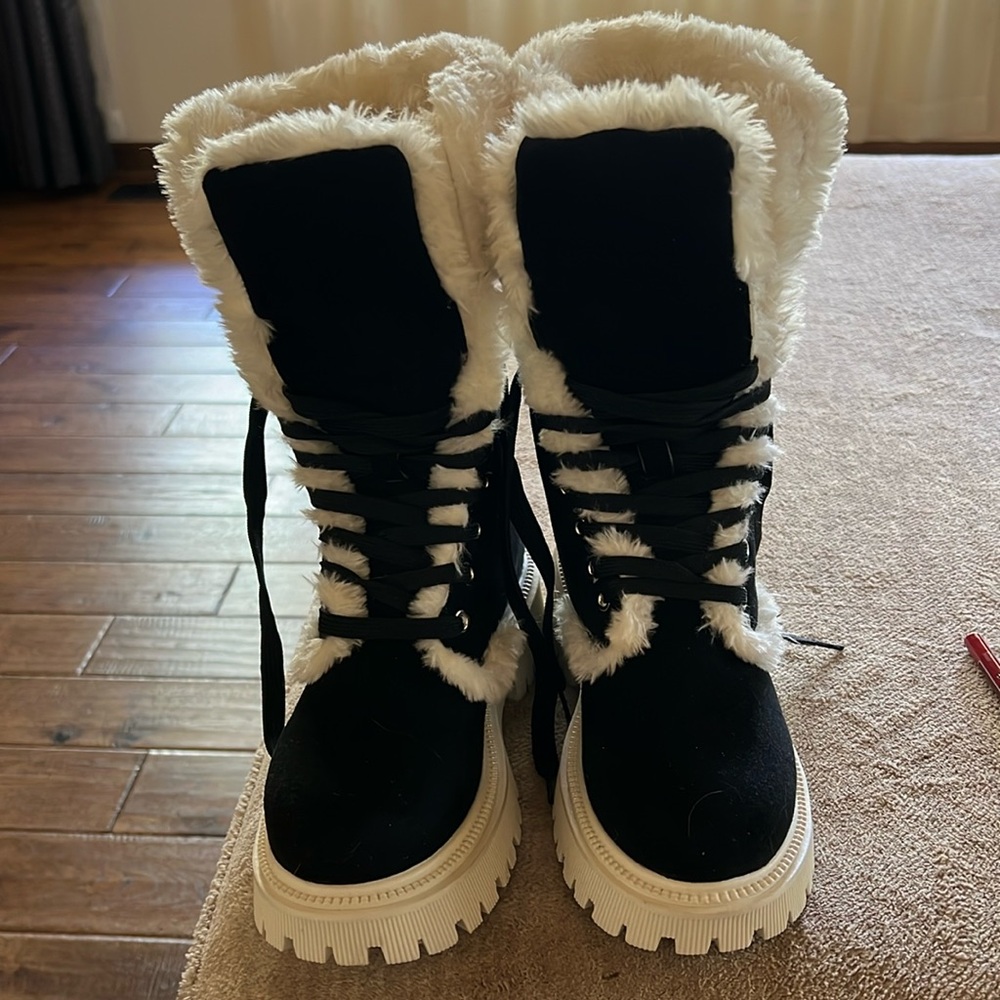 Black furry boots has a little heal.